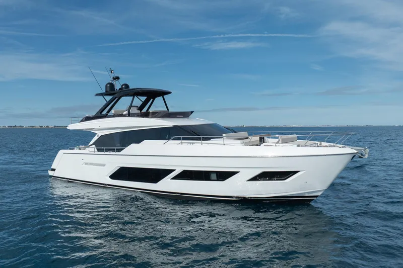  Yacht Photos Pics 2023 Ferretti Yachts 720 cruising on open water under clear blue skies.