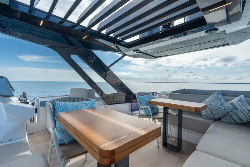  Yacht Photos Pics Luxurious 2023 Ferretti Yachts 720 deck with modern seating and ocean view.