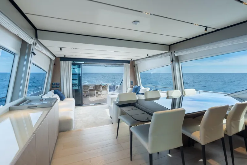  Yacht Photos Pics Luxurious interior of 2023 Ferretti Yachts 720 with ocean view and elegant dining area.