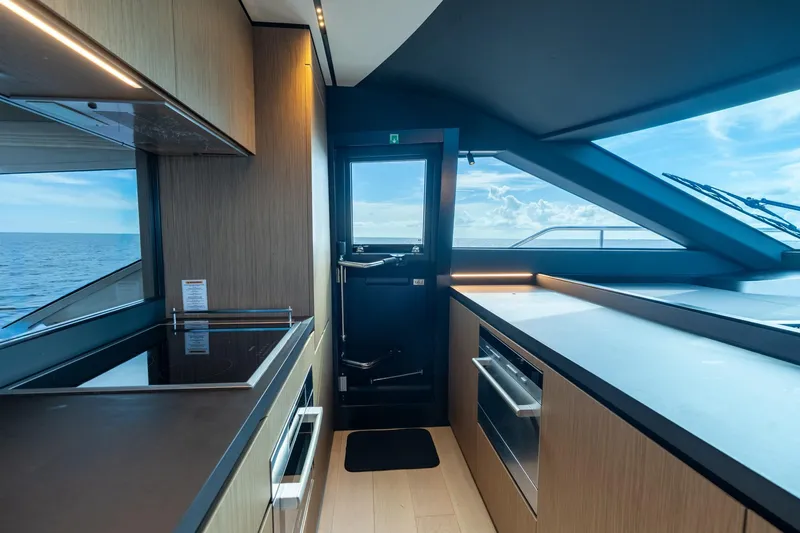  Yacht Photos Pics Luxurious kitchen interior of 2023 Ferretti Yachts 720 with ocean view.