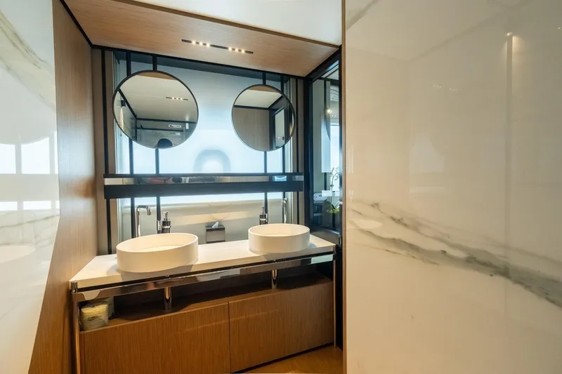  Yacht Photos Pics Luxurious bathroom in 2023 Ferretti Yachts 720, featuring dual sinks and modern design.