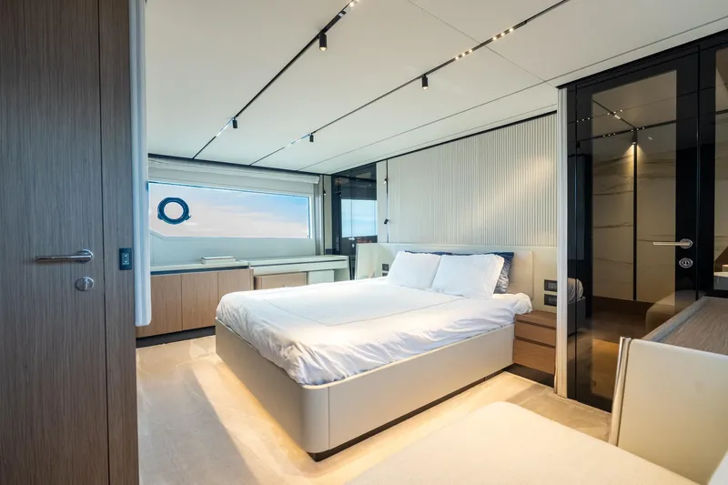  Yacht Photos Pics Luxurious bedroom interior of 2023 Ferretti Yachts 720, featuring modern design and elegant furnishings.