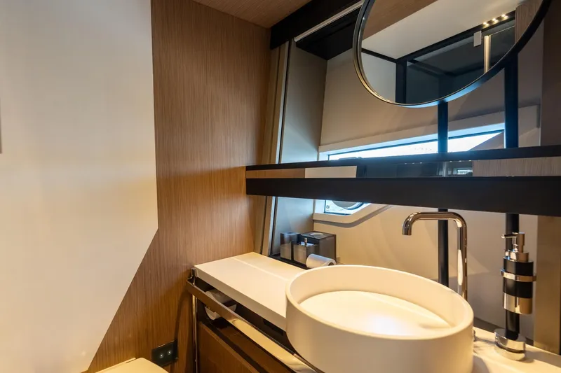  Yacht Photos Pics Luxurious bathroom interior of 2023 Ferretti Yachts 720 with modern sink and mirror.