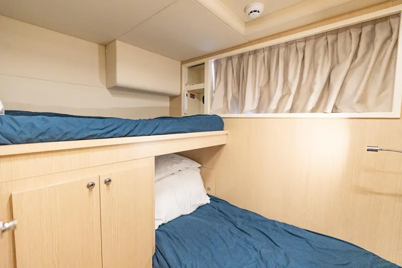  Yacht Photos Pics Interior cabin of 2023 Ferretti Yachts 720 with bunk beds and wooden finish.