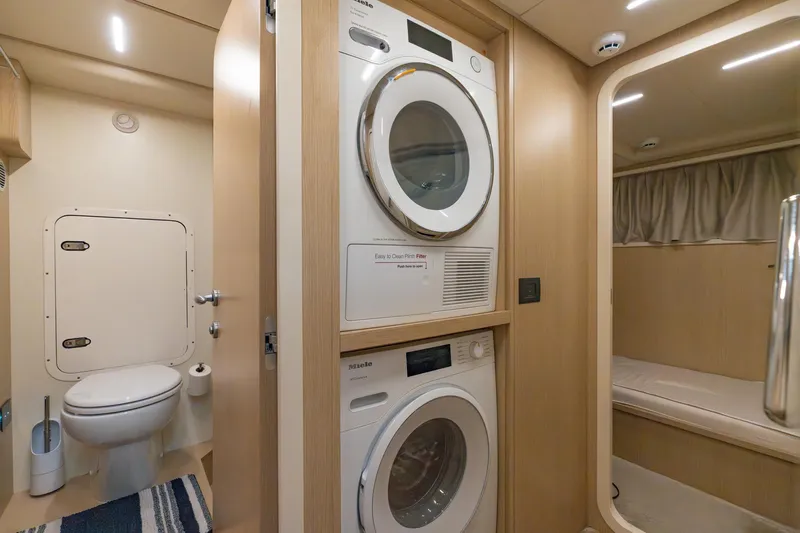  Yacht Photos Pics Laundry area and bathroom in 2023 Ferretti Yachts 720, featuring modern appliances.