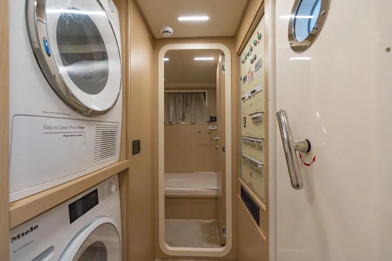  Yacht Photos Pics Laundry area and control panel inside 2023 Ferretti Yachts 720, featuring modern appliances.