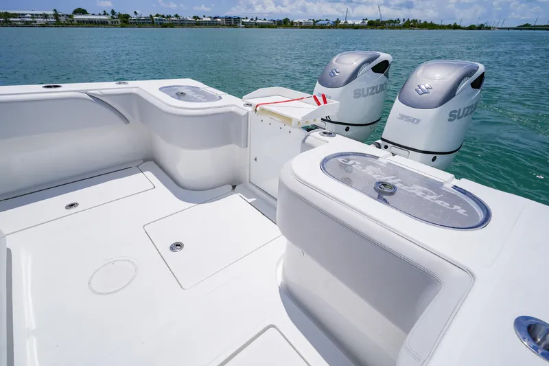  Yacht Photos Pics 2023 SeaHunter 31 Tournament boat with dual Suzuki engines on calm water.