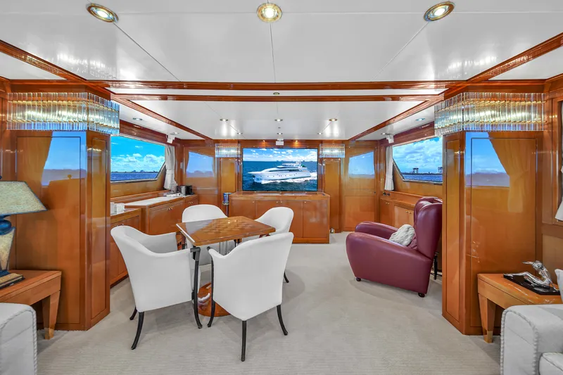  Yacht Photos Pics Luxurious interior of 1998 Sanlorenzo 100SL yacht with elegant seating and panoramic windows.