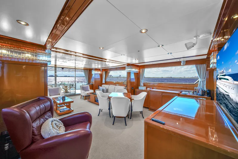  Yacht Photos Pics Luxurious interior of 1998 Sanlorenzo 100SL yacht with elegant seating and panoramic windows.