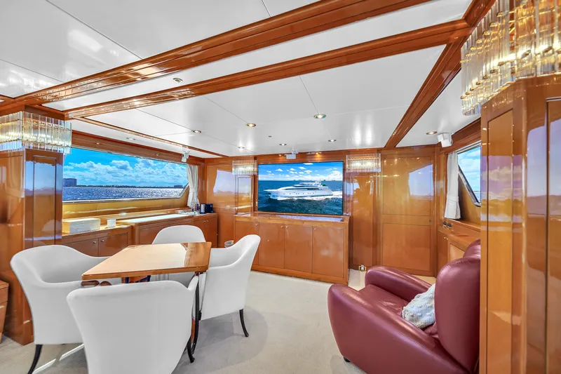  Yacht Photos Pics Luxurious interior of 1998 Sanlorenzo 100SL yacht with elegant seating and large windows.