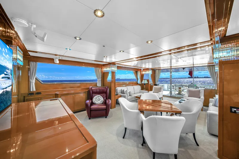  Yacht Photos Pics Luxurious interior of 1998 Sanlorenzo 100SL yacht with elegant seating and panoramic windows.