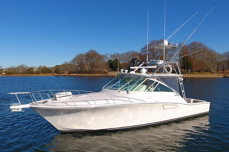 Tuna Daze Yacht Photos Pics 2004 Cabo Express boat on calm water under clear blue sky.