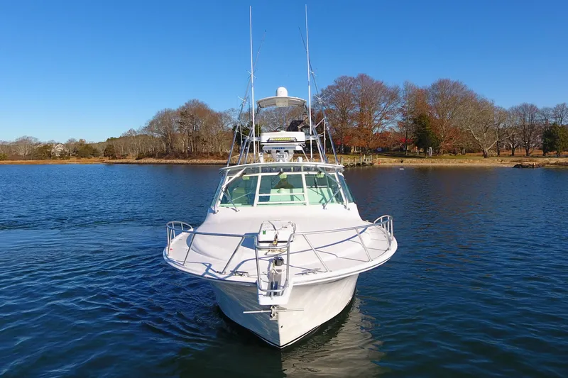 Tuna Daze Yacht Photos Pics 2004 Cabo Express boat on calm water with clear blue sky.