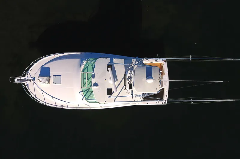 Tuna Daze Yacht Photos Pics Aerial view of 2004 Cabo Express boat on dark water.