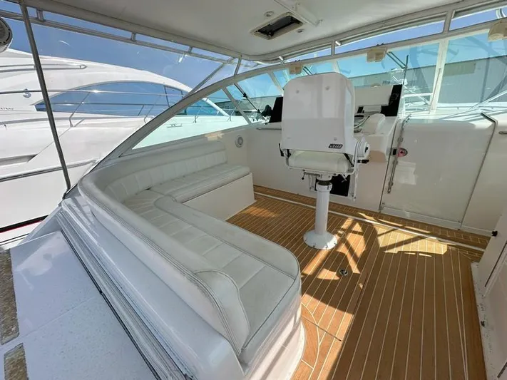 Tuna Daze Yacht Photos Pics 2004 Cabo Express boat interior with white seating and wooden flooring.