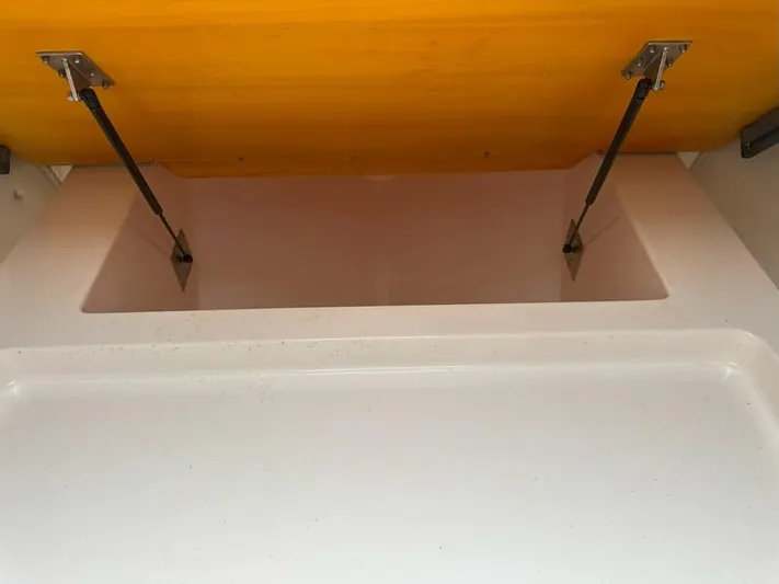 Tuna Daze Yacht Photos Pics Open storage compartment with hydraulic supports in a 2004 Cabo Express boat.