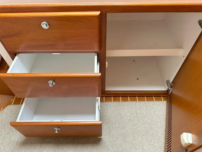 Tuna Daze Yacht Photos Pics Wooden cabinet with open drawers and shelves, Cabo Express 2004 model.