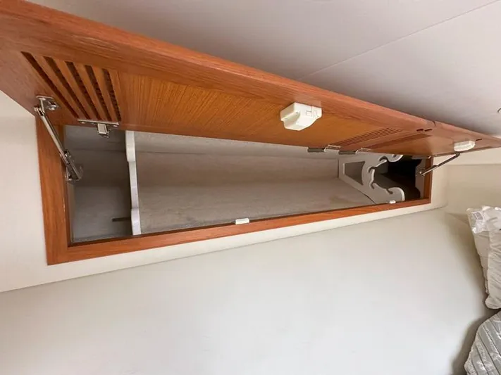 Tuna Daze Yacht Photos Pics Open wooden cabinet in 2004 Cabo Express boat interior.