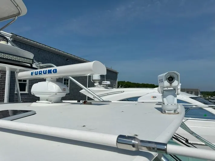 Tuna Daze Yacht Photos Pics Radar and camera equipment on a 2004 Cabo Express boat under clear blue skies.