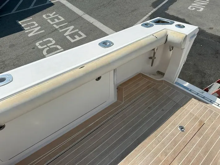 Tuna Daze Yacht Photos Pics 2004 Cabo Express boat deck with wood finish and storage compartments.