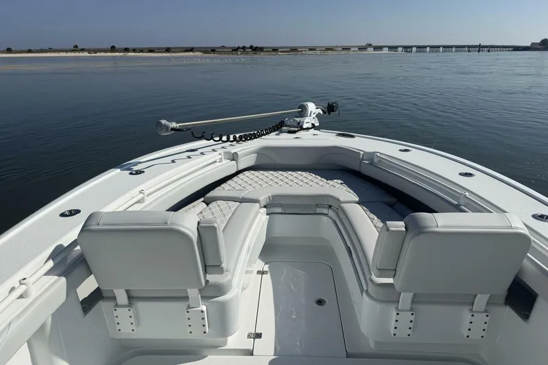  Yacht Photos Pics 2025 Yellowfin 26 Hybrid boat with spacious seating on calm water.