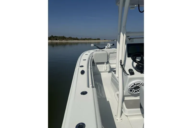  Yacht Photos Pics 2025 Yellowfin 26 Hybrid boat on calm water, showcasing sleek design and modern features.