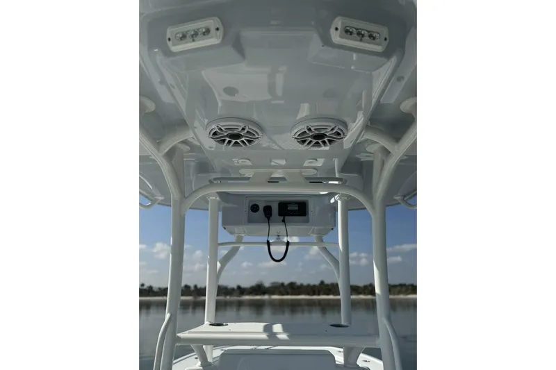 Yacht Photos Pics 2025 Yellowfin 26 Hybrid boat interior with speakers and electronics, showcasing modern design.