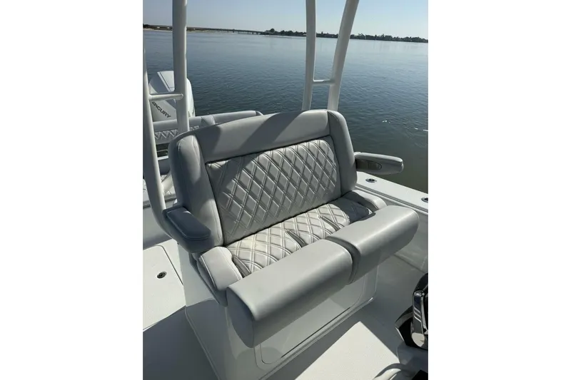  Yacht Photos Pics 2025 Yellowfin 26 Hybrid boat seat with quilted upholstery, overlooking calm water.