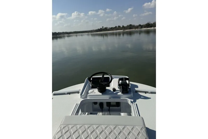  Yacht Photos Pics 2025 Yellowfin 26 Hybrid boat dashboard with serene lake view.