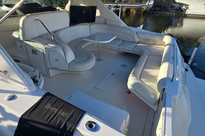 Lemaar Yacht Photos Pics 1995 Sea Ray 450 Sundancer yacht with spacious seating and table on deck.