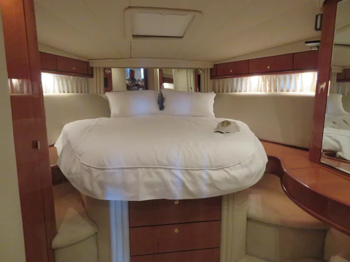  Yacht Photos Pics Luxurious cabin interior of 2001 Sea Ray 510DA yacht with cozy bed and elegant wood finish.