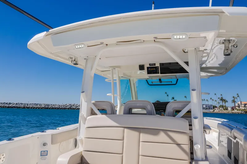 Robin Ann Yacht Photos Pics 2018 Boston Whaler 380 Outrage boat interior with seating, ocean view, and clear blue sky.