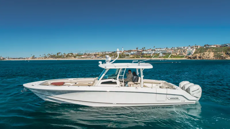 Robin Ann Yacht Photos Pics 2018 Boston Whaler 380 Outrage boat cruising on clear blue water.