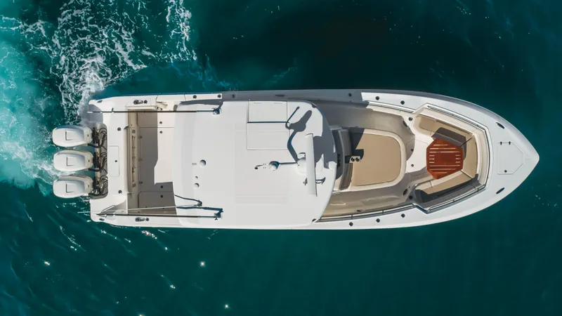 Robin Ann Yacht Photos Pics Aerial view of 2018 Boston Whaler 380 Outrage boat cruising on clear blue water.