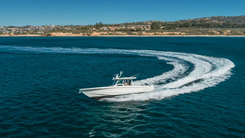 Robin Ann Yacht Photos Pics Boston Whaler 380 Outrage 2018 cruising on blue ocean near coastline.