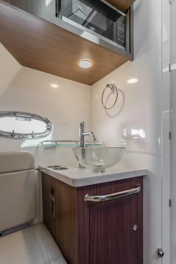 Robin Ann Yacht Photos Pics 2018 Boston Whaler 380 Outrage cabin interior with sink and microwave.