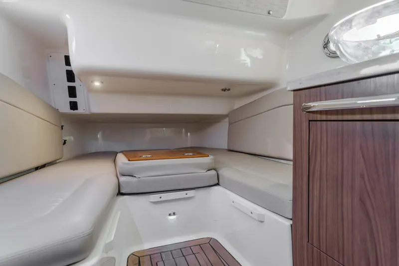 Robin Ann Yacht Photos Pics Interior cabin of 2018 Boston Whaler 380 Outrage with cushioned seating and wood accents.