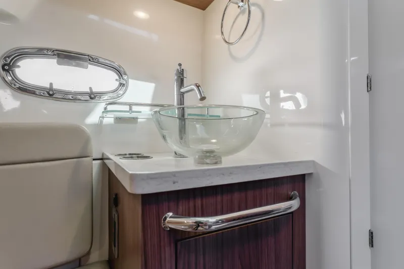 Robin Ann Yacht Photos Pics Luxurious bathroom interior of 2018 Boston Whaler 380 Outrage with glass sink and modern fixtures.