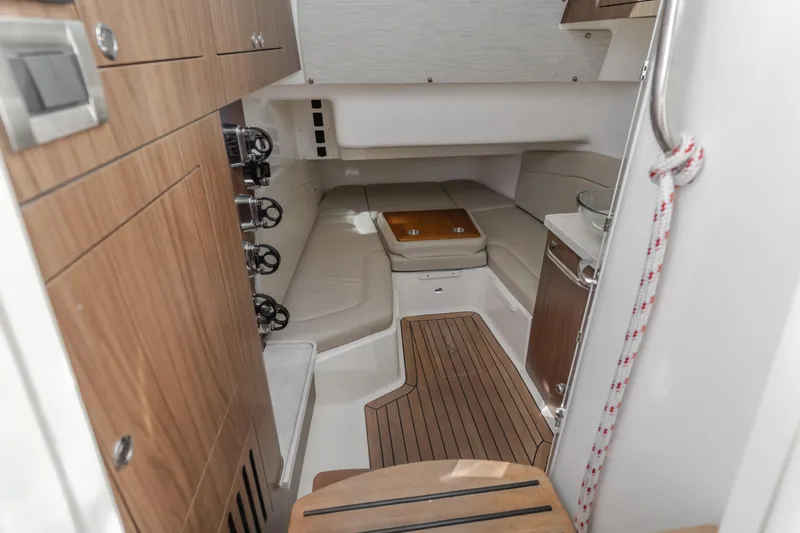 Robin Ann Yacht Photos Pics 2018 Boston Whaler 380 Outrage cabin interior with wood accents and seating area.