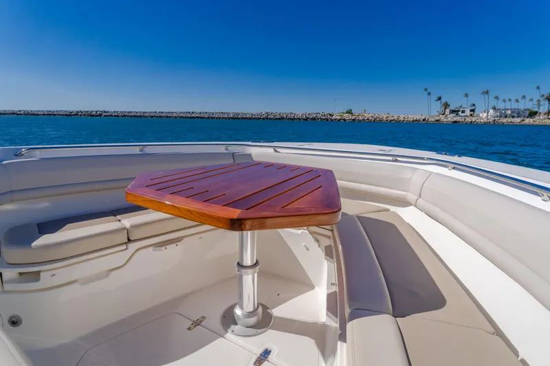 Robin Ann Yacht Photos Pics Boston Whaler 380 Outrage 2018 boat interior with wooden table and seating.