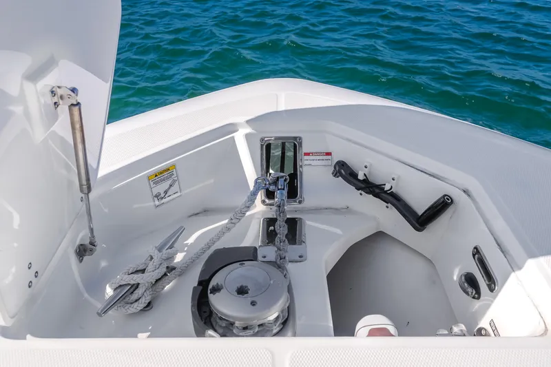 Robin Ann Yacht Photos Pics 2018 Boston Whaler 380 Outrage anchor compartment with rope and winch, on blue water.