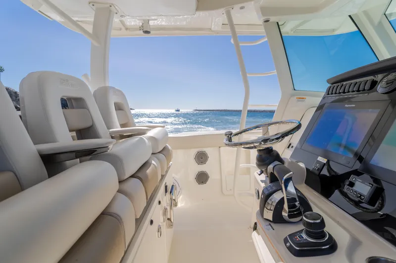 Robin Ann Yacht Photos Pics 2018 Boston Whaler 380 Outrage cockpit with modern controls and ocean view.