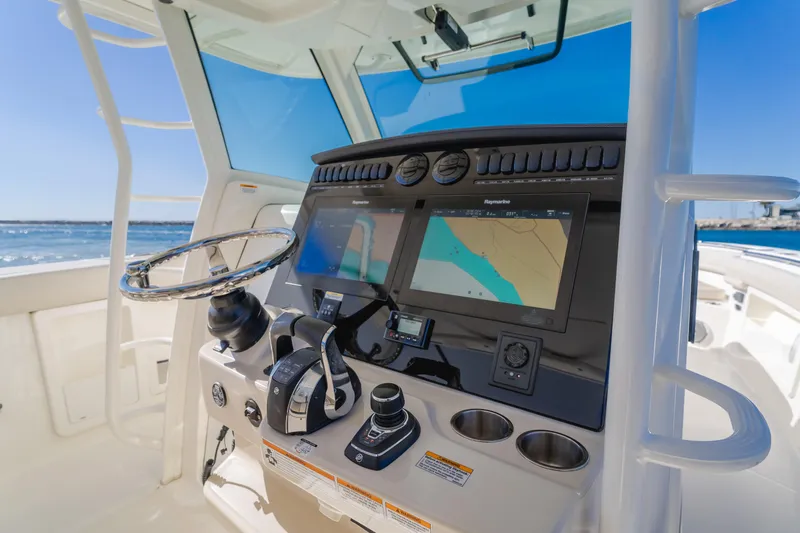 Robin Ann Yacht Photos Pics Boston Whaler 380 Outrage 2018 helm with navigation screens and steering wheel.