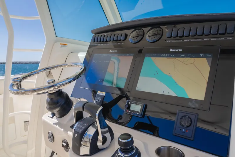 Robin Ann Yacht Photos Pics Boston Whaler 380 Outrage 2018 helm with dual navigation screens and steering wheel.