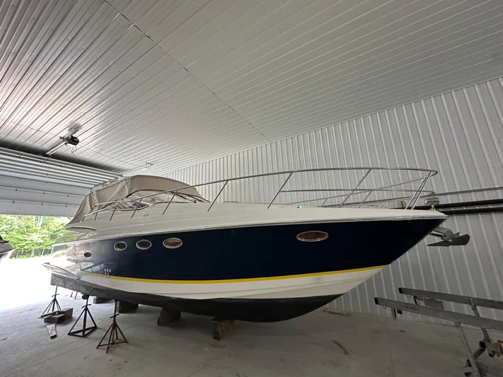  Yacht Photos Pics 2004 Regal Commodore 3860 yacht in storage, featuring a sleek blue and white design.