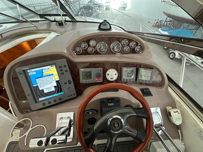  Yacht Photos Pics Helm of 2004 Regal Commodore 3860 with navigation instruments and steering wheel.
