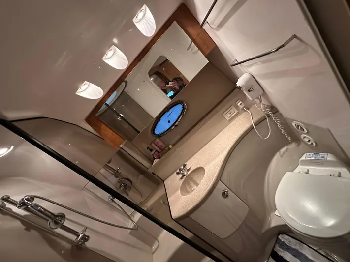  Yacht Photos Pics Bathroom interior of 2004 Regal Commodore 3860 yacht with shower, sink, and toilet.