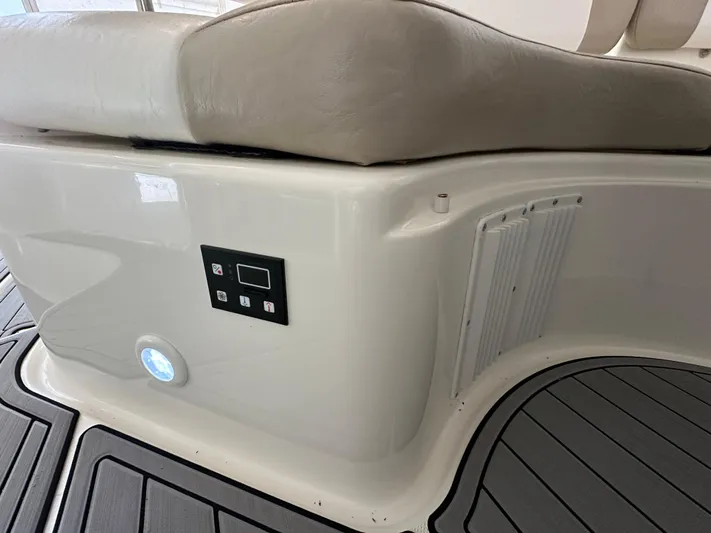  Yacht Photos Pics 2004 Regal Commodore 3860 boat interior with cushioned seating and control panel.