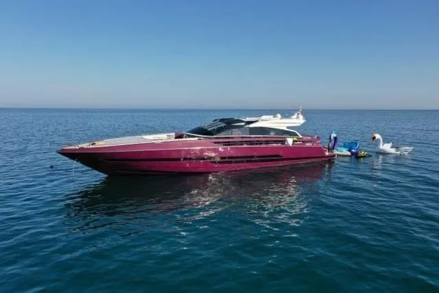 Argonaut Yacht Photos Pics Luxurious 2011 Baia ONE HUNDRED yacht on calm blue sea with inflatable swan.