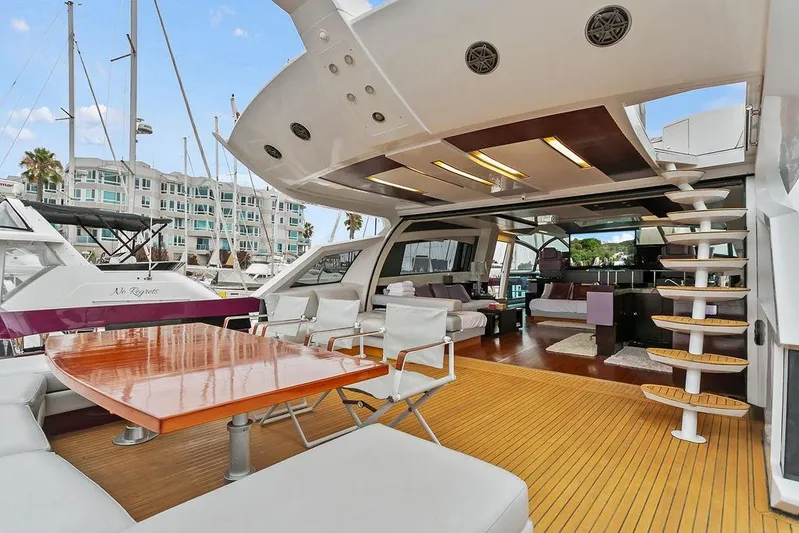 Argonaut Yacht Photos Pics Luxurious 2011 Baia yacht with spacious deck, modern seating, and elegant wooden table.